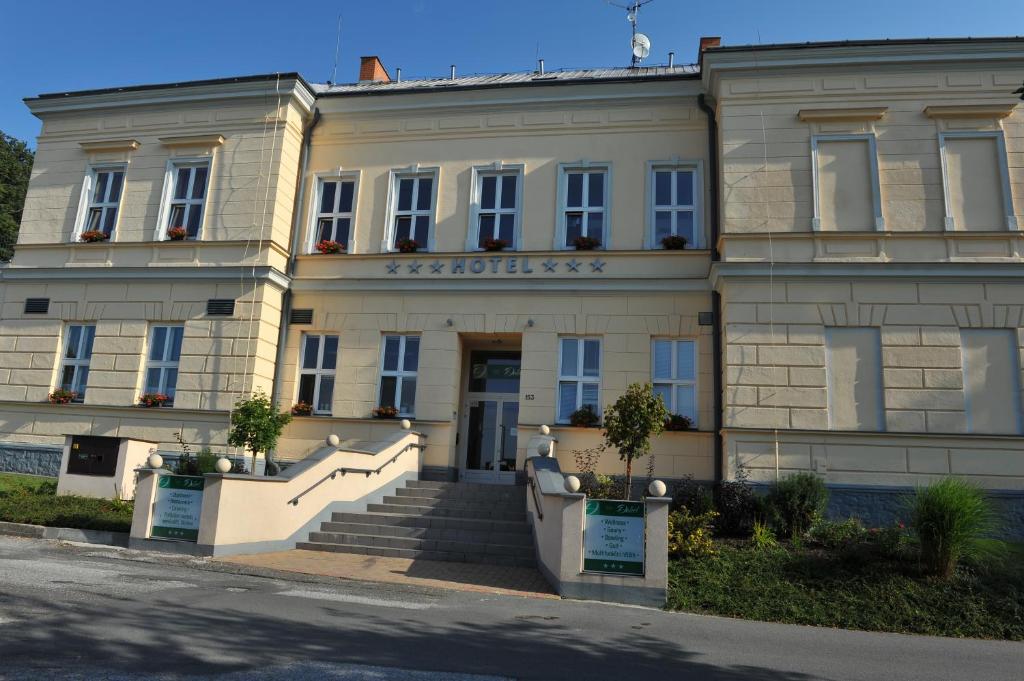 a building with a staircase in front of it at Hotel Dakol in Petrovice u Karviné