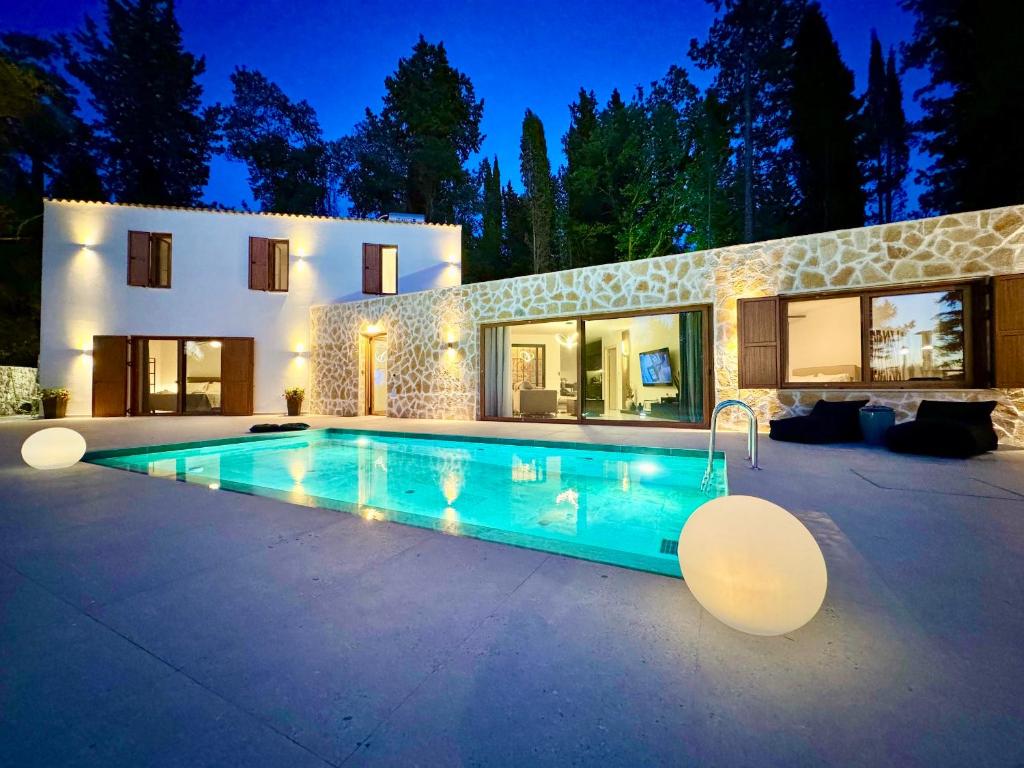 a swimming pool in front of a house at Domenico Morani Luxury Villa Concept with private pool by DadoVillas in Gastouri