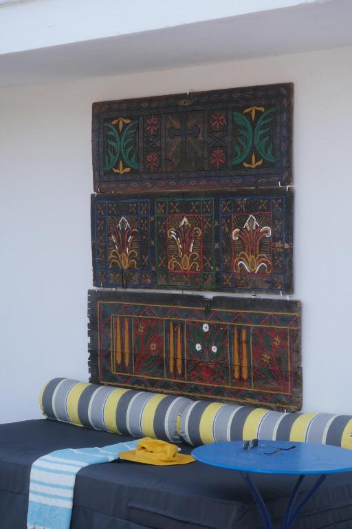 a room with a table with a large painting on the wall at Blue Marina Sea View & Private beach Apartment in Sivota in Sivota