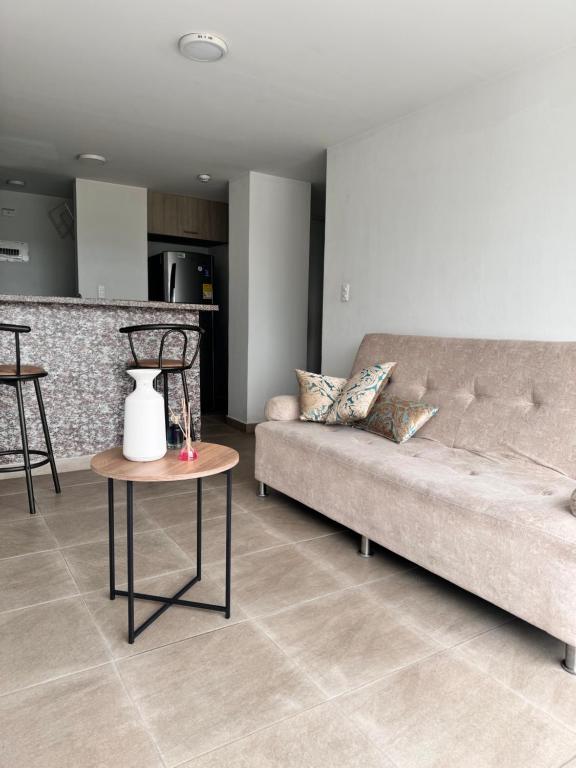 a living room with a couch and a table at MIRADOR DE CASTILLA - Sector CENTRAL in Manizales