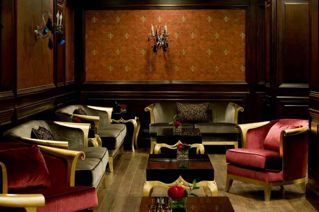 a living room with couches and chairs and a table at Barceló Cairo Pyramids in Cairo