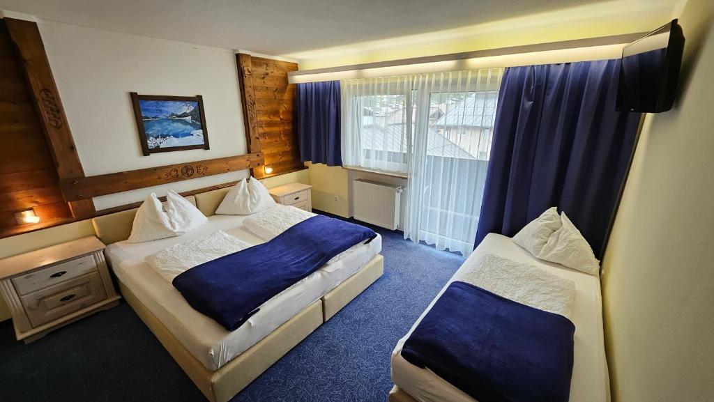Postel nebo postele na pokoji v ubytování Panoramahotel