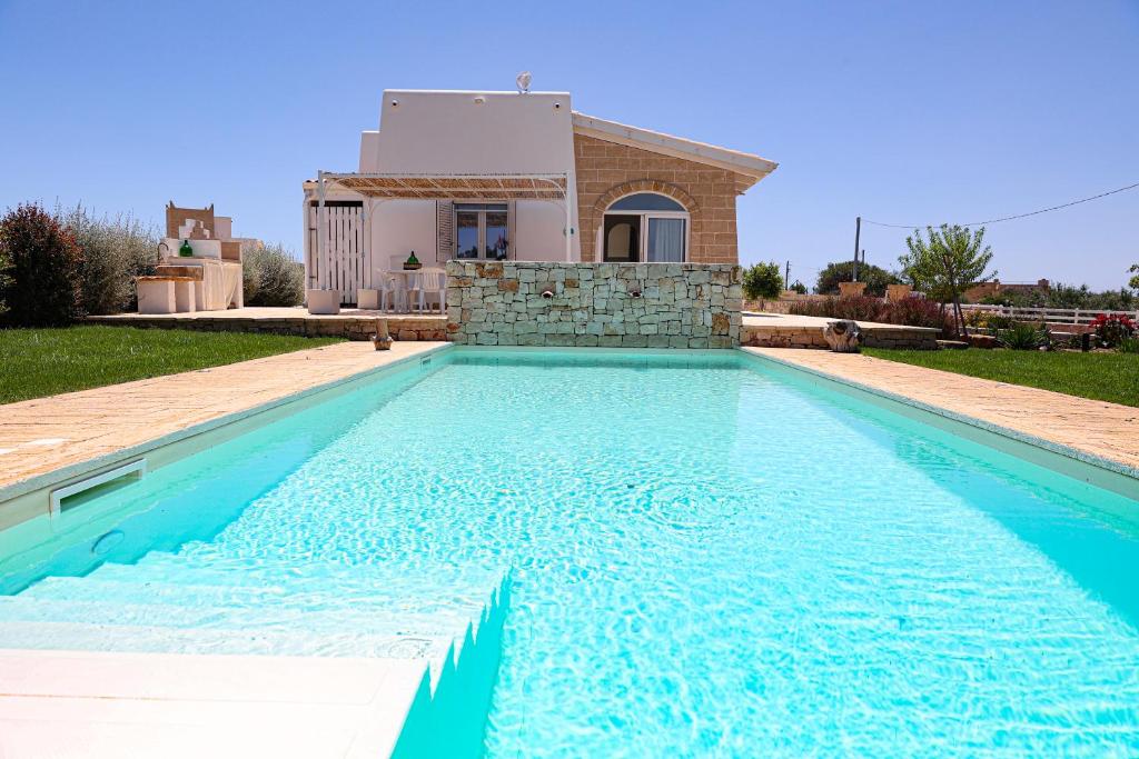 a swimming pool in front of a villa at Villa Brezza dello Ionio in Marina di Pescoluse