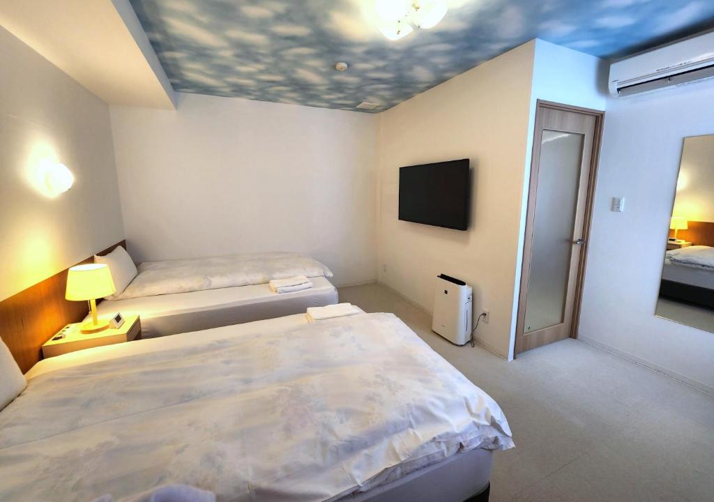 Postel nebo postele na pokoji v ubytování Hotel Nishimura