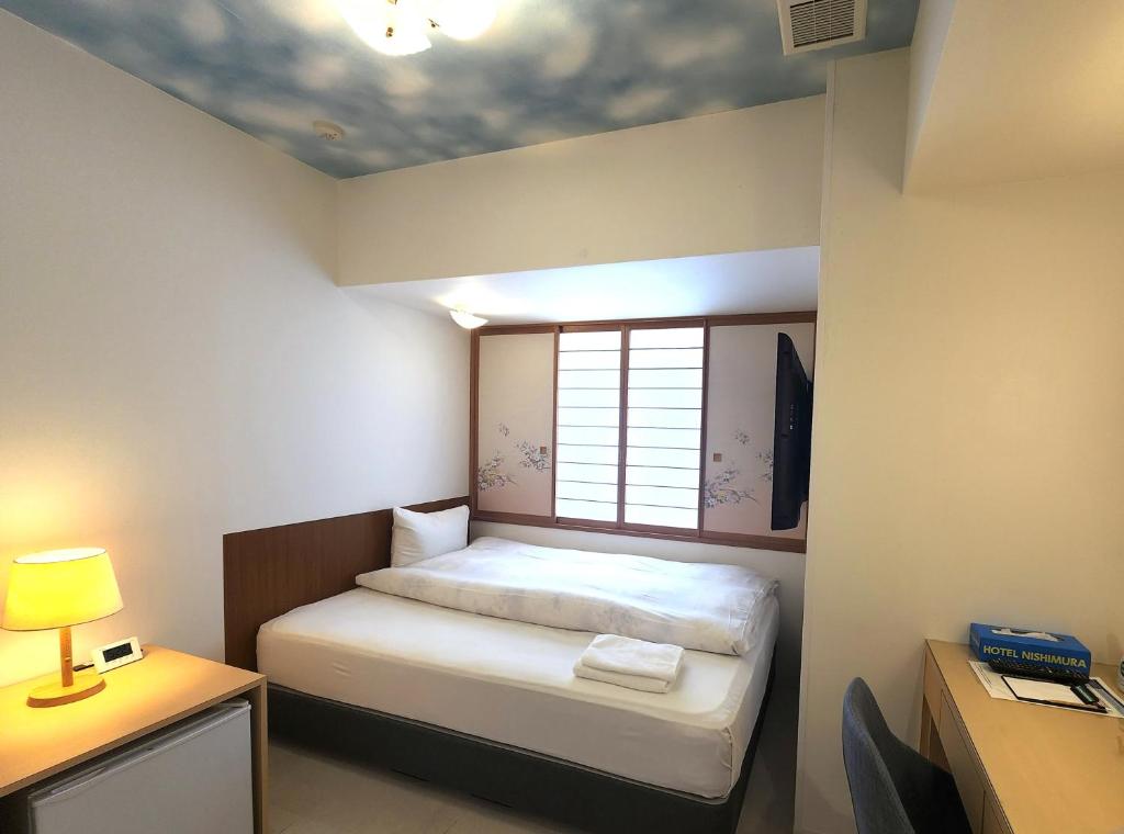 Postel nebo postele na pokoji v ubytování Hotel Nishimura