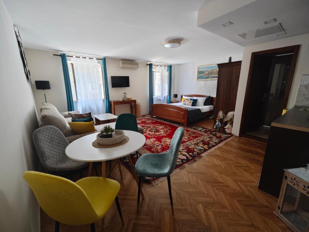a living room with a table and chairs at Beatrix Suites in Budva