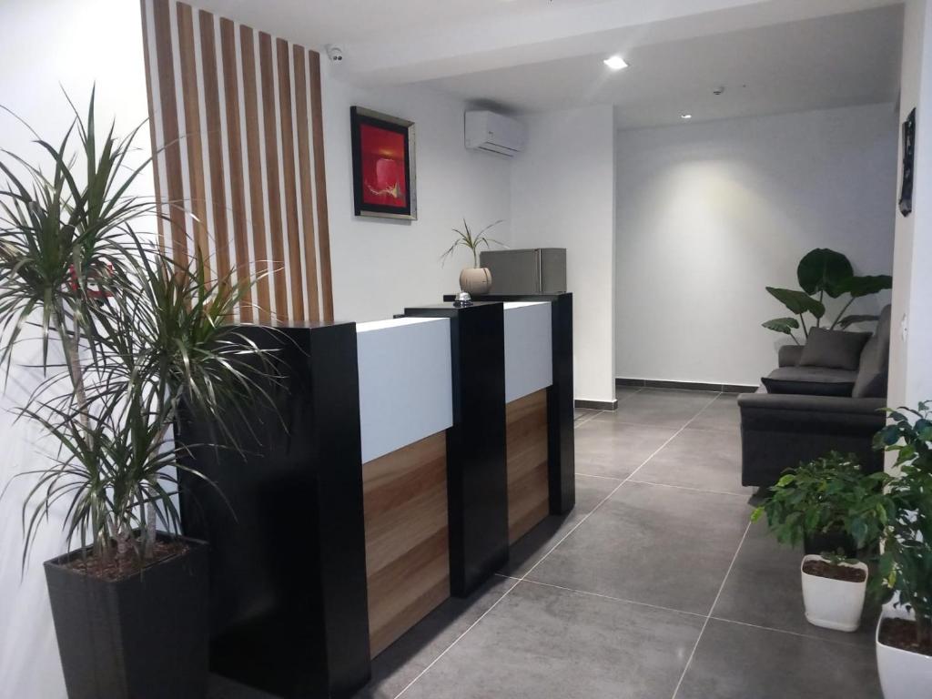 a lobby with potted plants and a reception desk at Hotel Ksamili in Ksamil