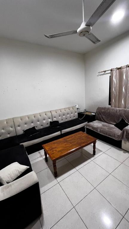 a living room with a couch and a coffee table at Offer if booked at least 1 week Elegance Modern 1-Bedroom Close to Everything in Ajman 