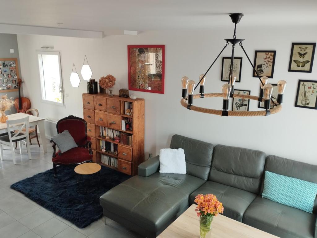 a living room with a couch and a table at Maison Centre bourg in Nort-sur-Erdre