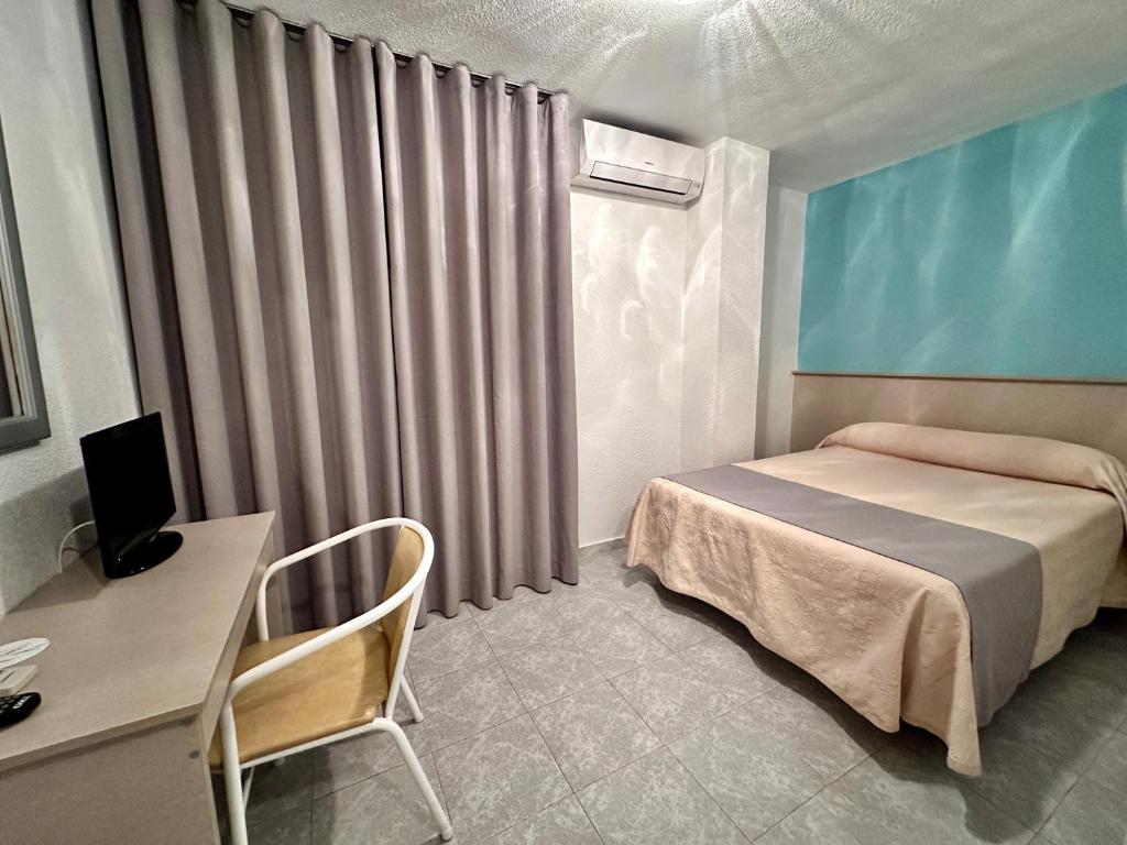 Postel nebo postele na pokoji v ubytování Hotel El Paraíso