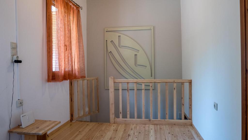 a room with a wooden staircase and a window at Τhemis House in Chania Town