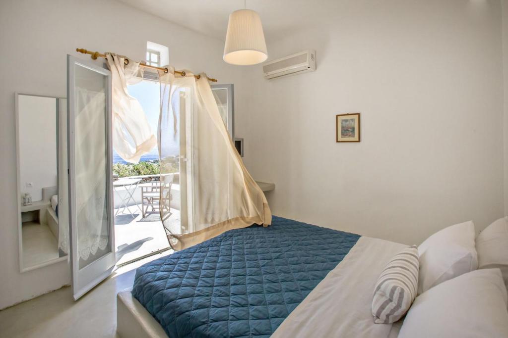 a bedroom with a bed and a window with a view at Iris house Agios Sostis in Agios Sostis