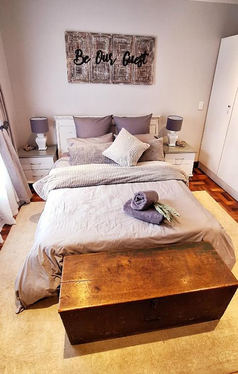a bedroom with two beds and a sign that reads be our guest at Stay at Fairway in Centurion