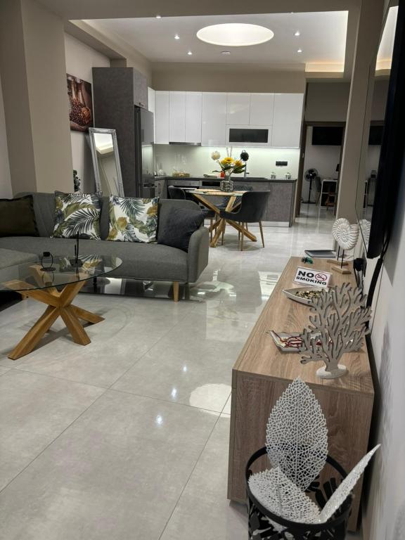 a living room with a couch and a table at Menda Suite in Heraklio