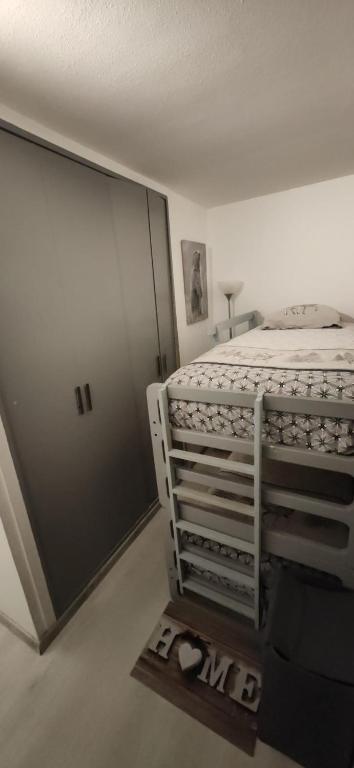 a bedroom with a bed and a sliding door at Le petit Chamois in Saint-Gervais-les-Bains