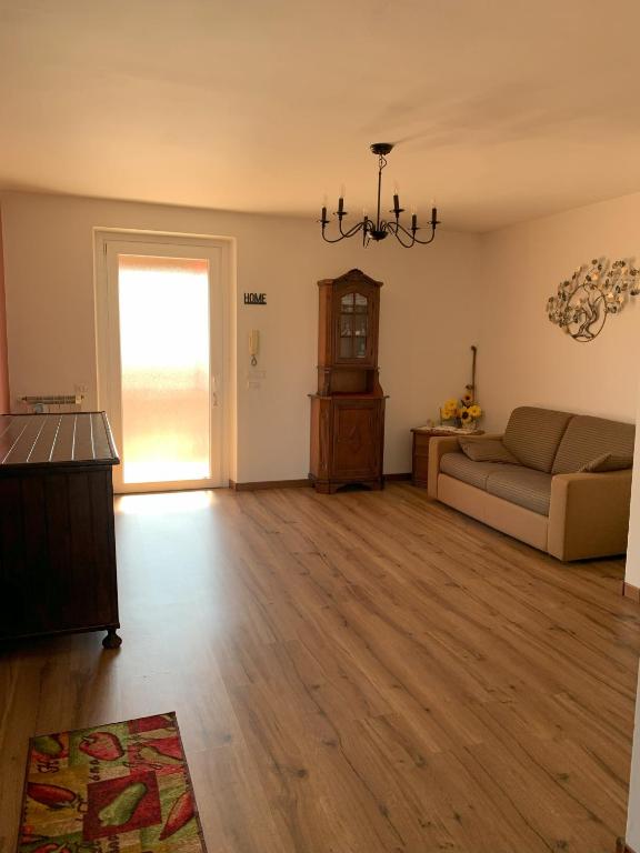 a living room with a couch and a window at Casalebellavista in Tarquinia