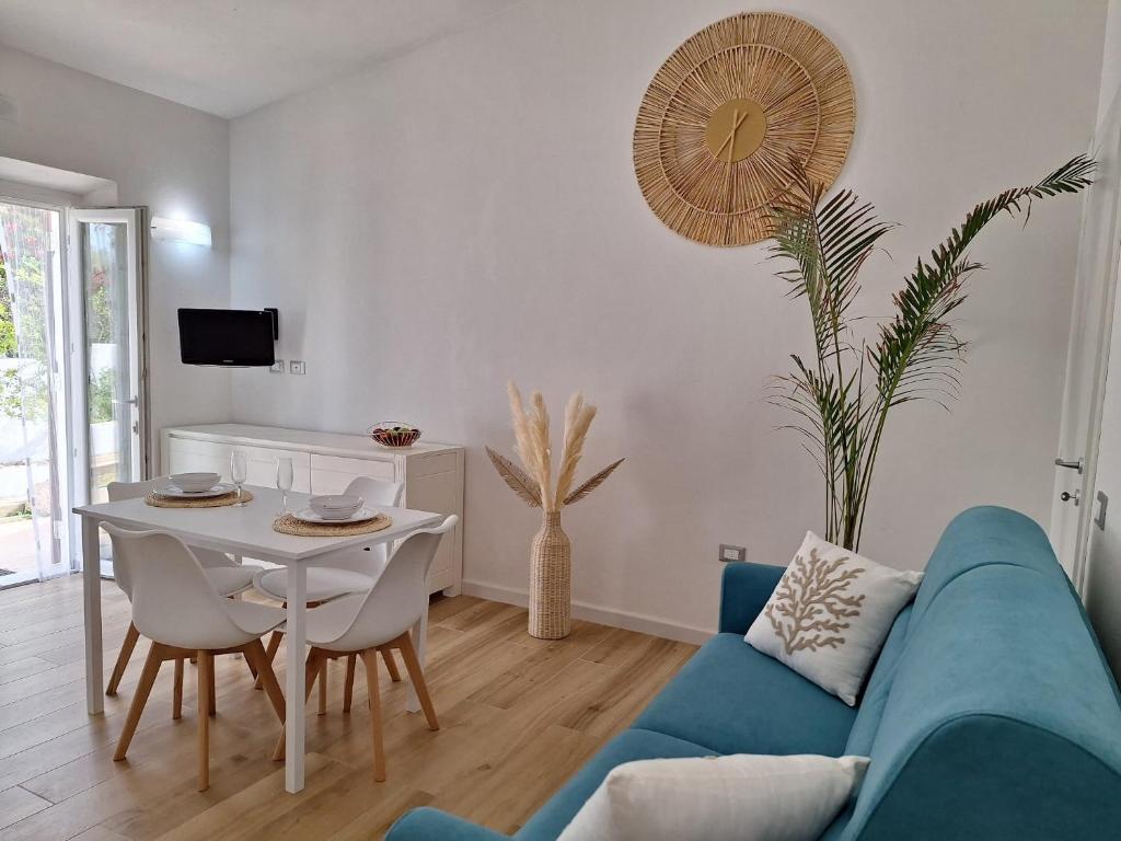 a living room with a blue couch and a table at Holiday House in Villa Beatrice in Porto Istana