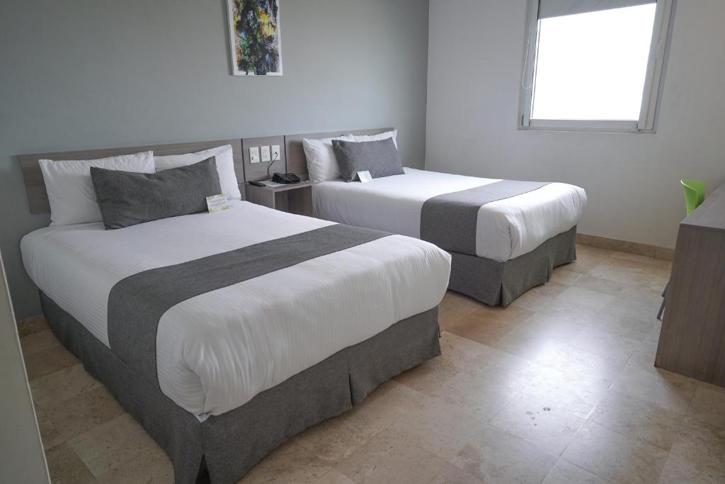Postel nebo postele na pokoji v ubytování SR Hotel