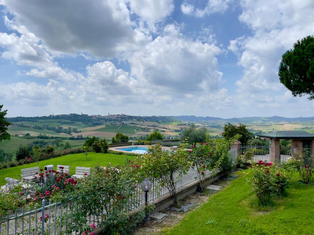 a garden with flowers and a fence and a pool at Tenuta Landora in Grazzano Badoglio