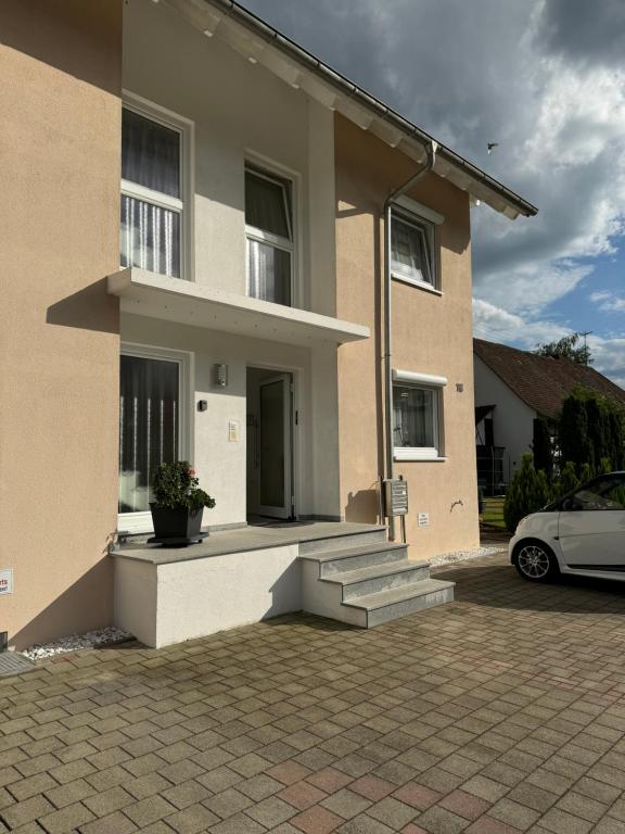 a house with a car parked in front of it at By Stelwag in Bermatingen