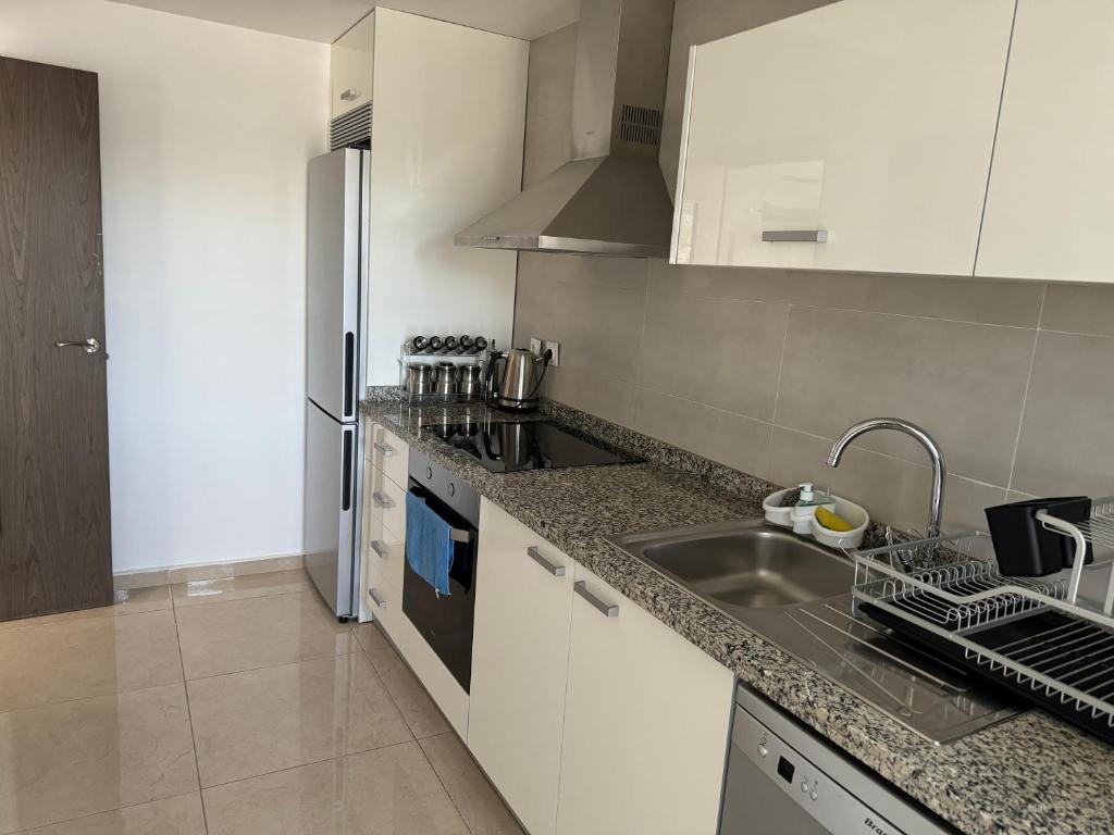 a kitchen with a sink and a counter top at Luxury apartment near TGV station and the beach in Tangier