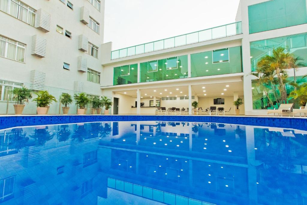 a swimming pool in front of a building at Pietro Angelo Hotel in Foz do Iguaçu