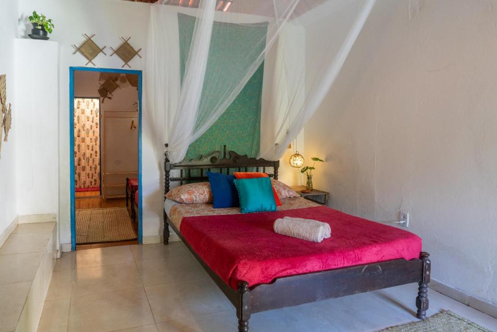 En eller flere senge i et værelse på Casamor Café e Hospedaria Praia de Algodões