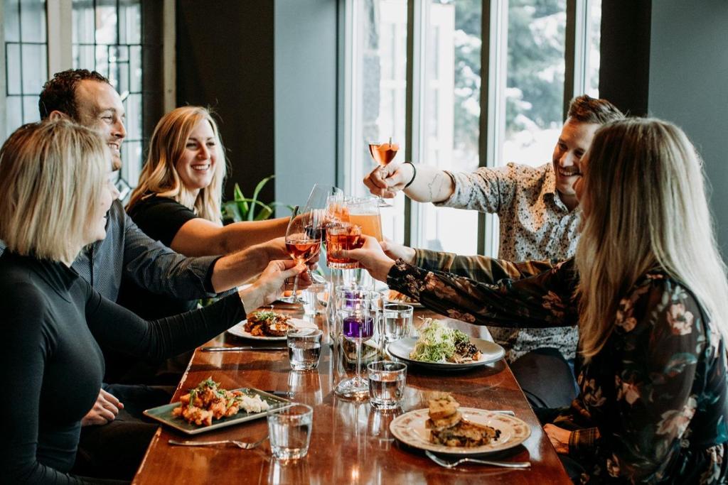 a group of people sitting around a table drinking wine at Pan Pacific Whistler Village Centre in Whistler