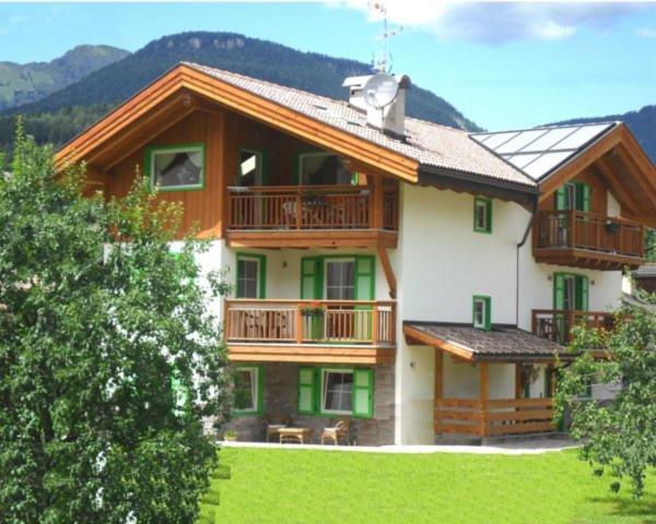a large house with a balcony on the side of it at Affittacamere Famiglia Ceschini in Tesero