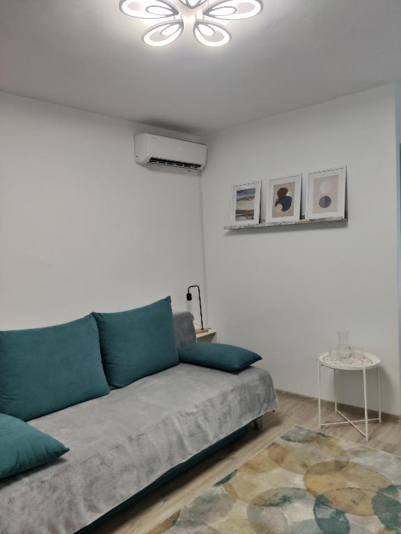 a living room with a couch and a ceiling at Harmony House in Oradea