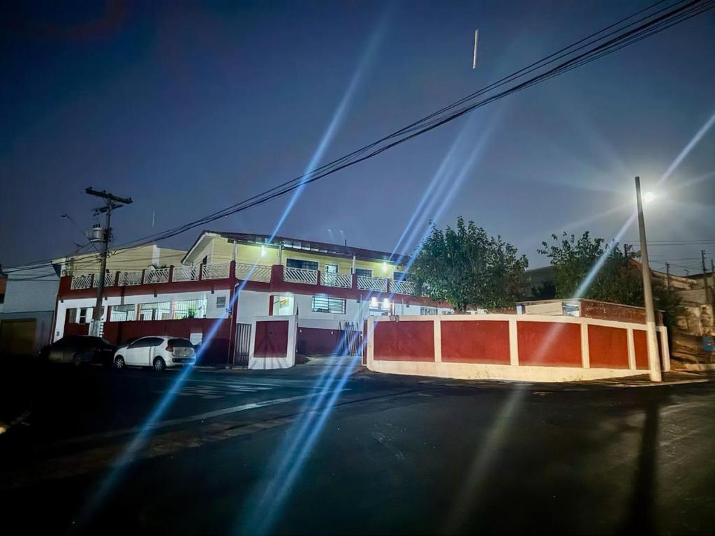 a view of a street at night with a building at Pousada B&B - na cidade Capivari-SP in Capivari