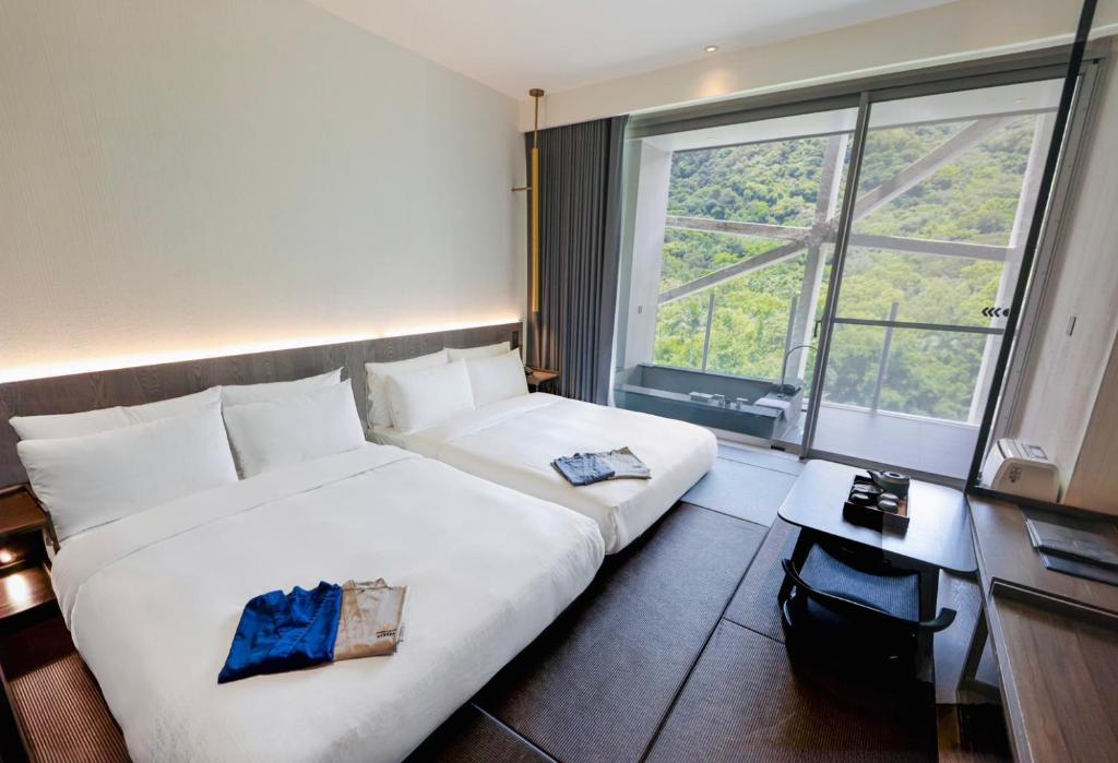 Postel nebo postele na pokoji v ubytování Orient Luxury Hotel-Jiaoxi