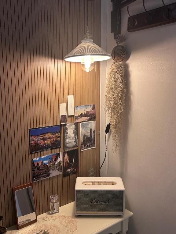 a room with a table with a microwave and a lamp at Momo House2 in Gimhae