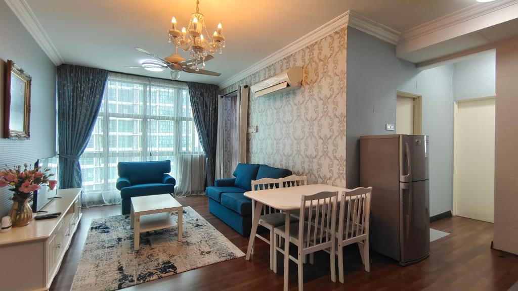 a kitchen and living room with a table and a refrigerator at SAFIYA Homestay Vista Alam in Shah Alam