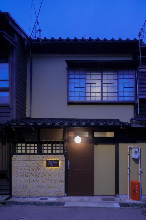 a building with a sign on the front of it at ZOPA Nishicho in Kanazawa