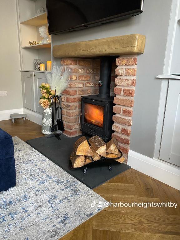 a brick fireplace with a stove in a living room at Harbour Heights Whitby in Whitby