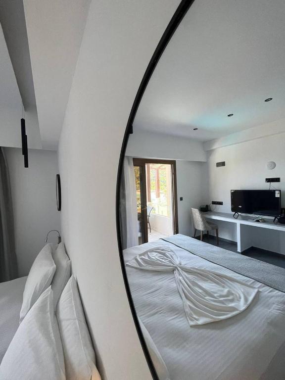 a mirror reflecting a bed in a bedroom at Blue Green Bay in Panormos Skopelos