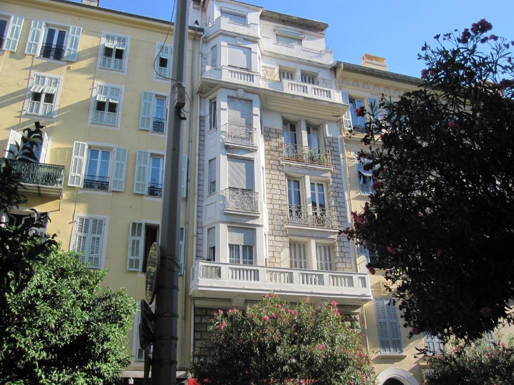 ein hohes Gebäude mit Balkon an der Seite in der Unterkunft Charmant appartement au centre de Nice in Nizza