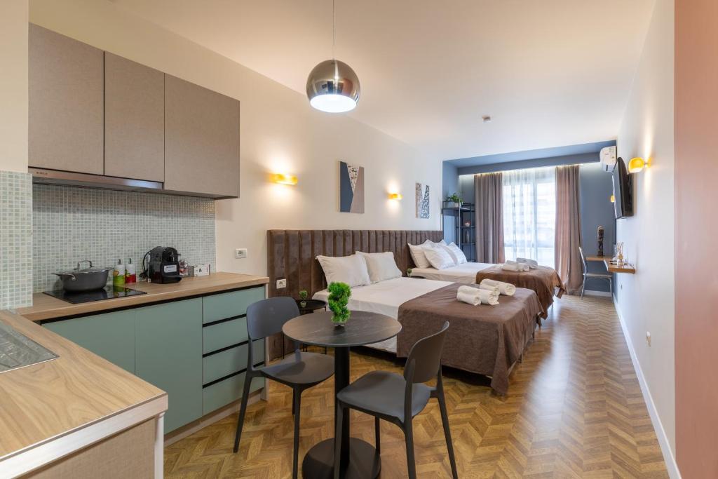 una cucina e un soggiorno con letto e tavolo di Luxury Suite Studio City Centre a Tirana
