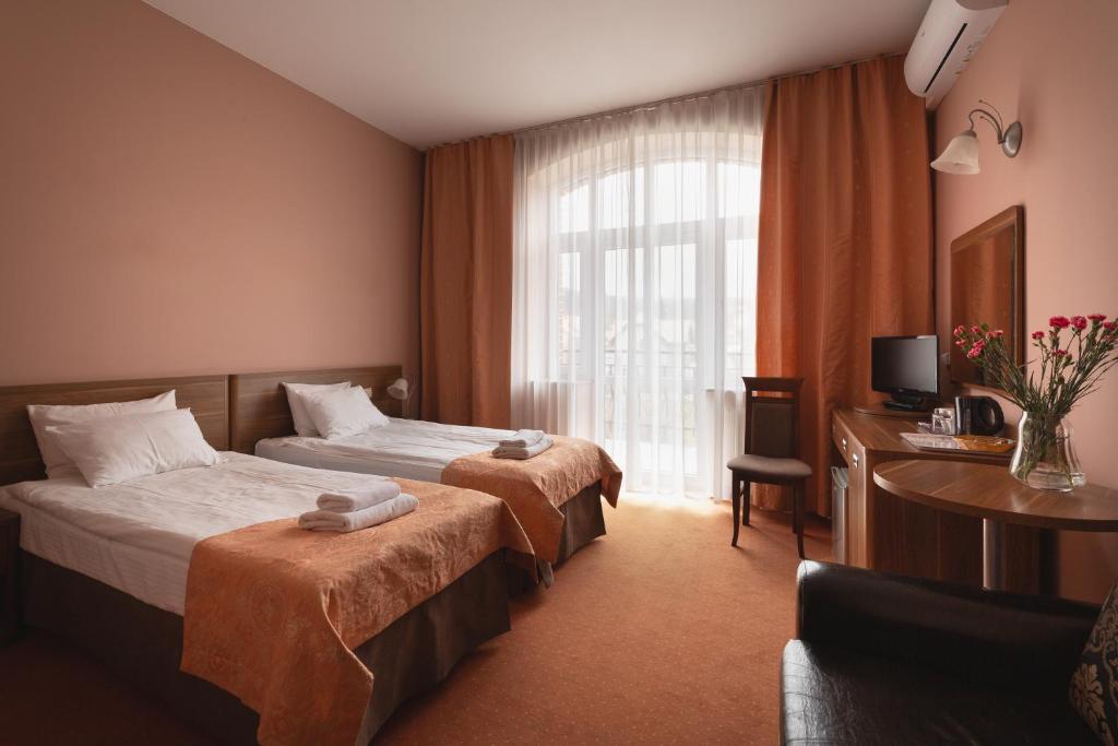 Posteľ alebo postele v izbe v ubytovaní Paria Hotel