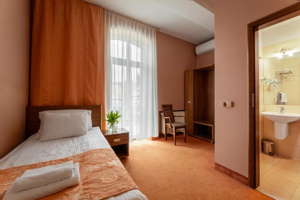 Posteľ alebo postele v izbe v ubytovaní Paria Hotel