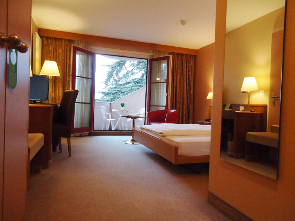 Postel nebo postele na pokoji v ubytování Hotel Le Cedre