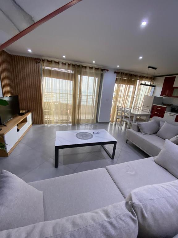 a living room with a couch and a coffee table at Luxury sea view duplex in Durrës
