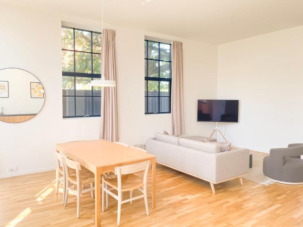 a living room with a table and a couch at Cozy and Bright Apartments with Private Car Park in Copenhagen