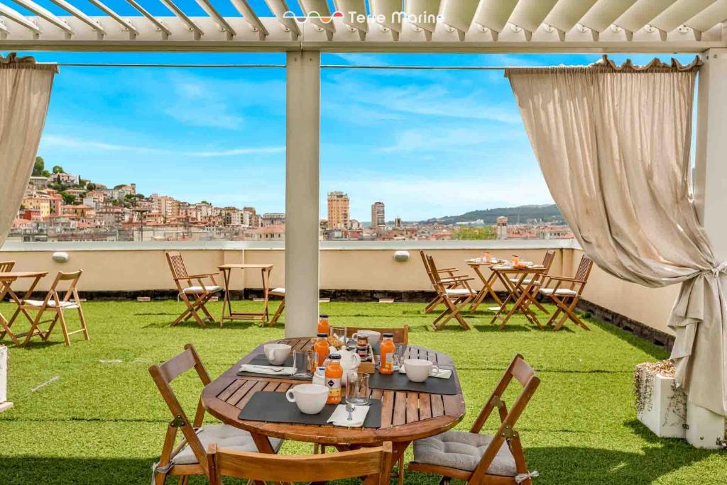 a table and chairs on a patio with a view at Vicci 57, Terre Marine in La Spezia