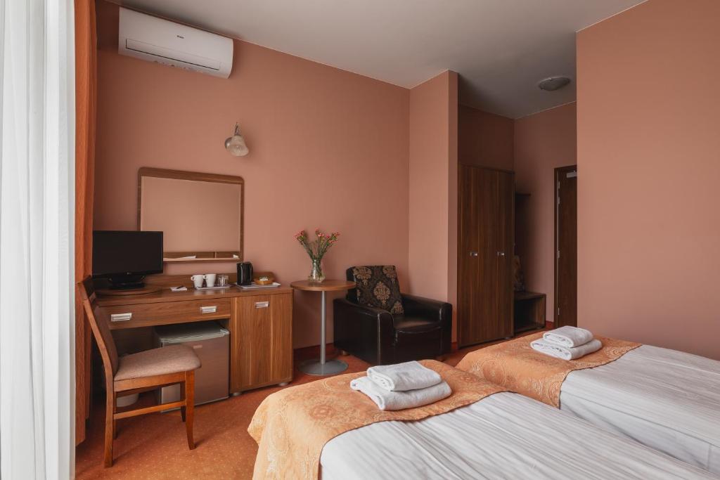 Posteľ alebo postele v izbe v ubytovaní Paria Hotel