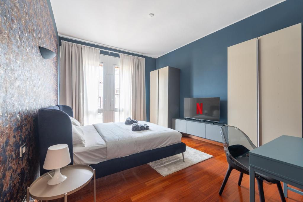 a bedroom with a bed and a table and a television at La dimora del Marchese in Duomo in Milan