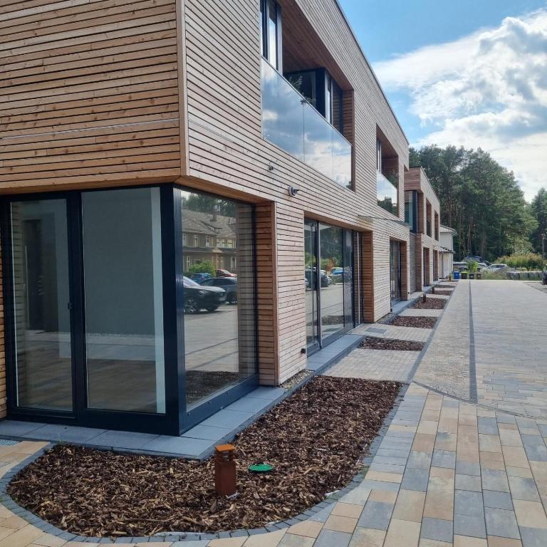 a building with glass windows on the side of it at Ferienwohnungen in Borkheide in Borkheide
