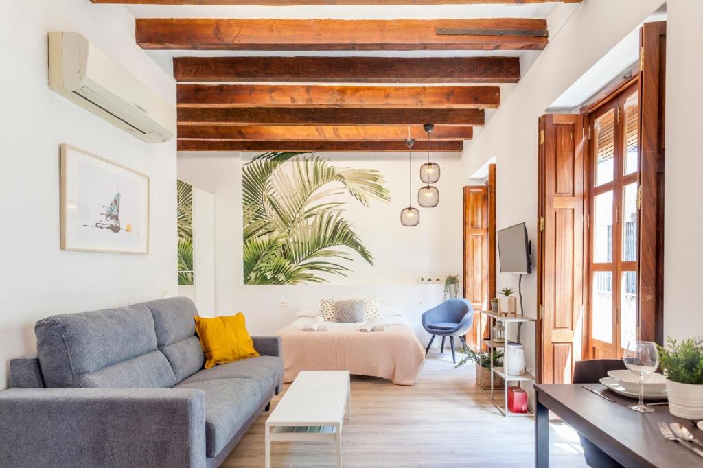 a living room with a couch and a table at Modern Flat by Mercado Central in Ciutat Vella in Valencia