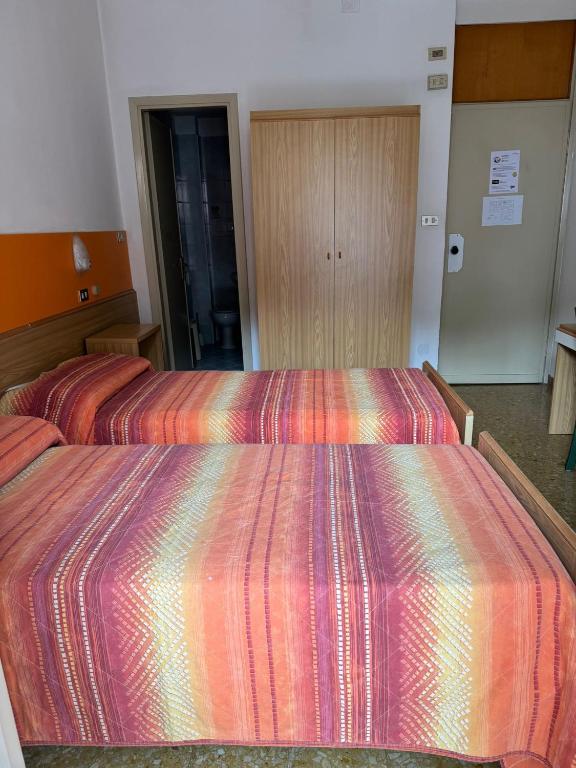 Postel nebo postele na pokoji v ubytování Hotel Garnì Capinera
